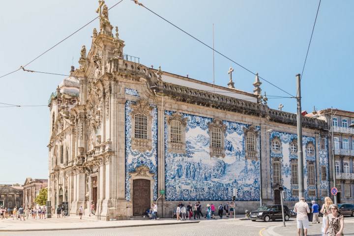 a group of people walking in front of a building