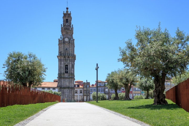 a small clock tower in front of a brick building