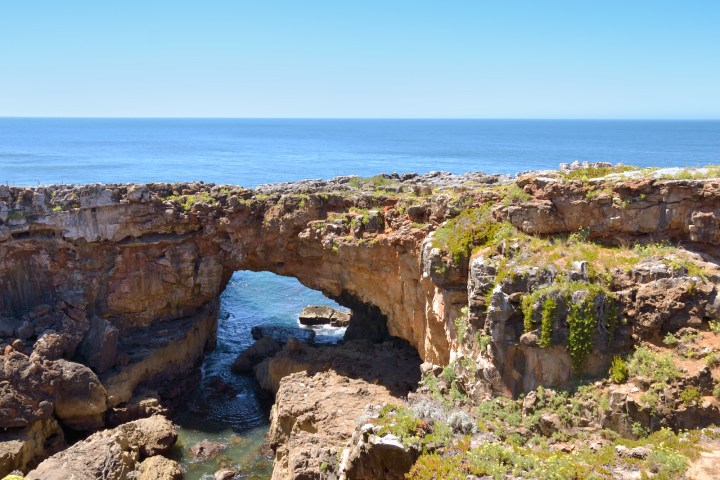 a rocky landscape with a body of water