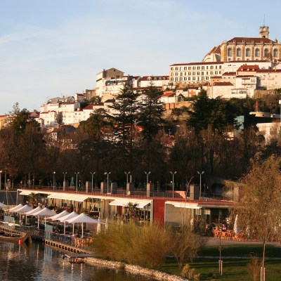 a bridge over a body of water with a city in the background