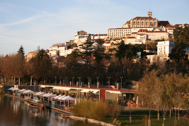 a bridge over a body of water with a city in the background