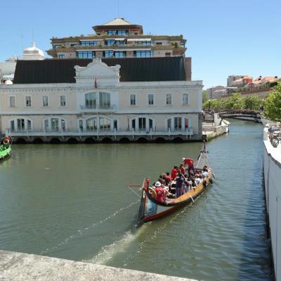 a boat floating along a river next to a body of water
