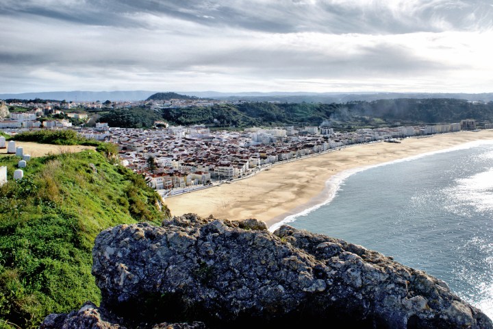 a rocky beach next to a body of water