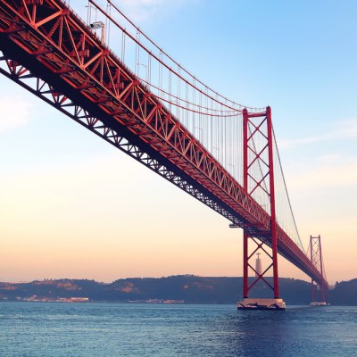 a train crossing a bridge over a body of water