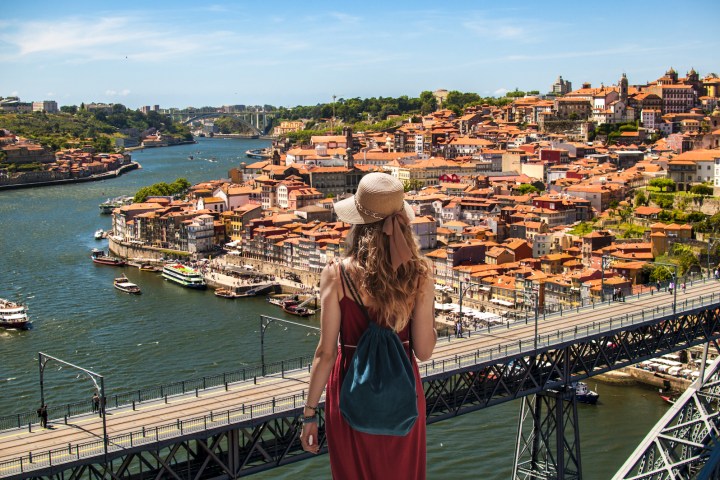 a group of people on a bridge over a body of water