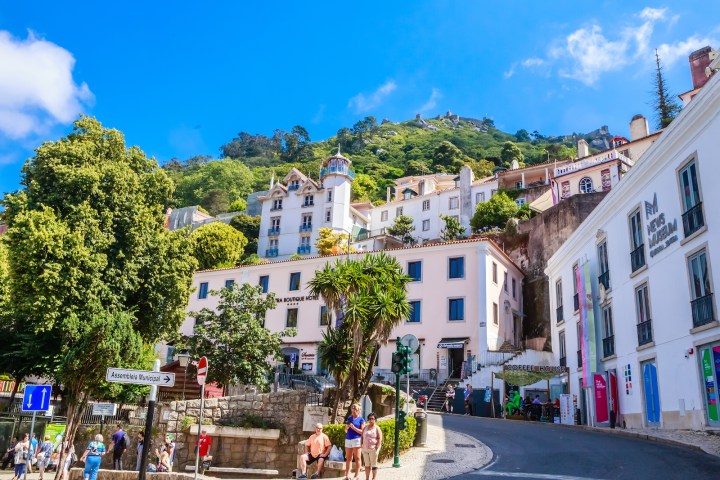 a group of people walking in front of a building
