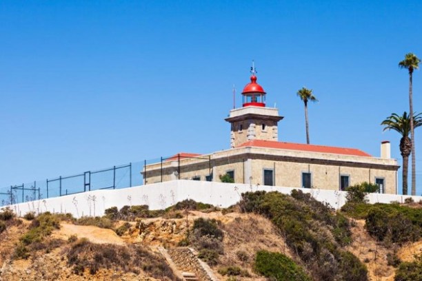 a large brick building with a tower in the background