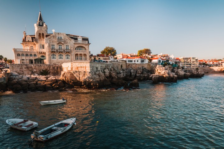 a small boat in a body of water with a city in the background
