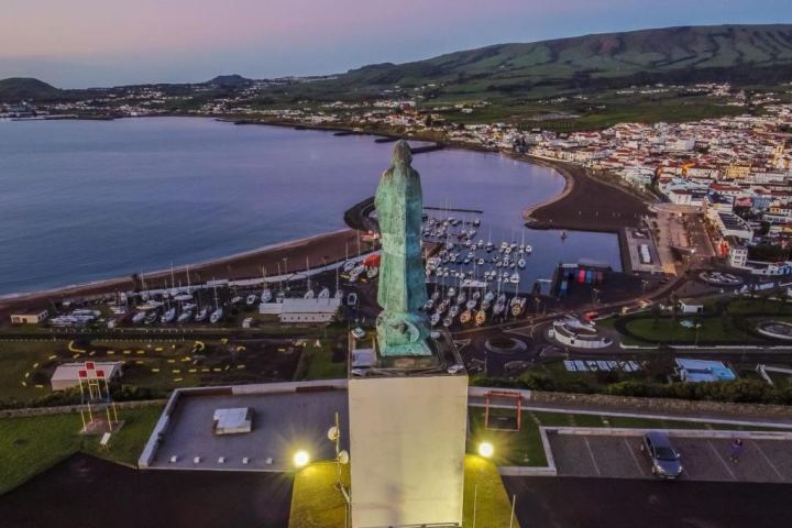 a bridge over a body of water with a city in the background