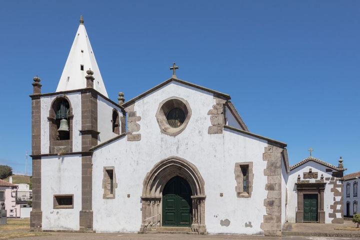 a church with a clock on the front of a building