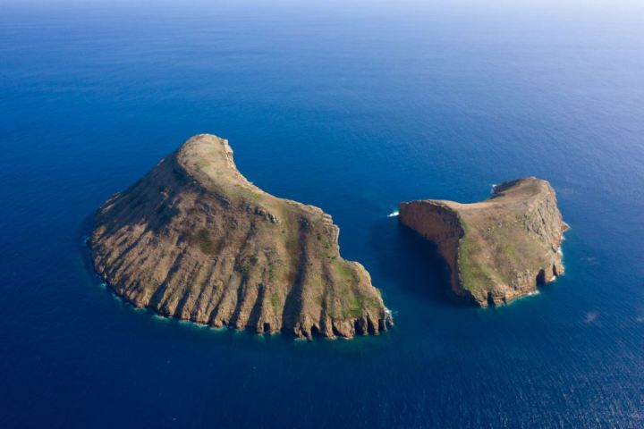 a large body of water with a mountain in the background