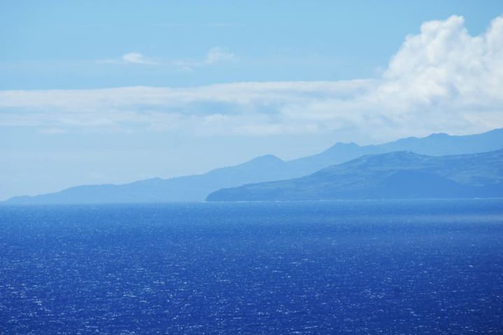 a large body of water with a mountain in the background