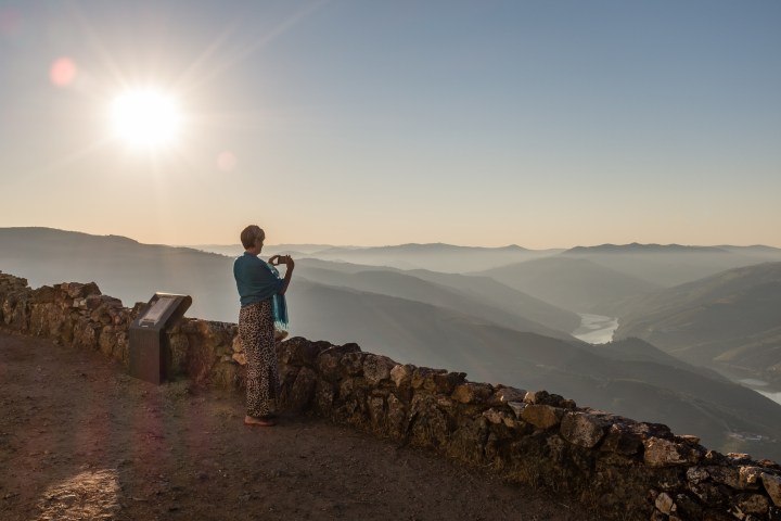 a man standing on a rocky hill