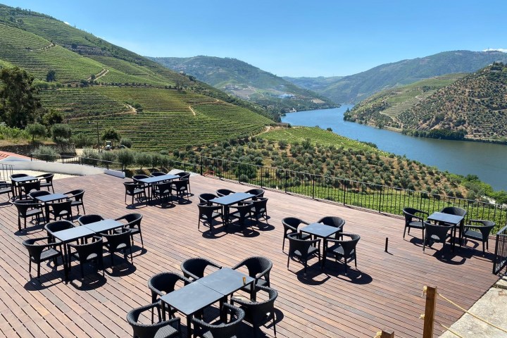 a group of people sitting on a bench with a mountain in the background
