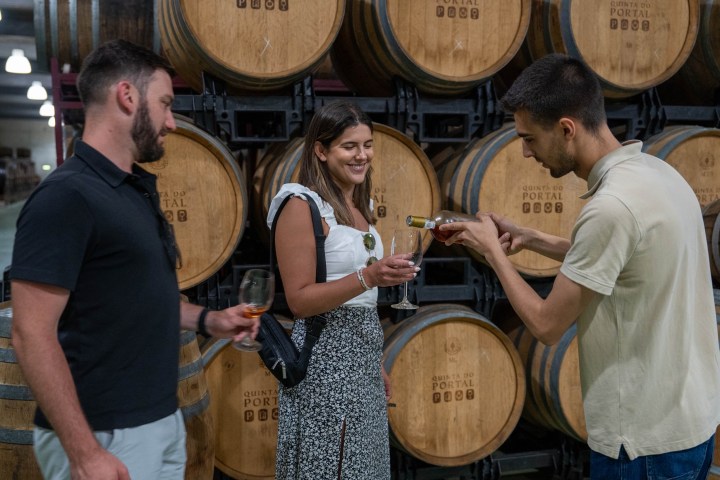 a group of people standing in front of a barrel
