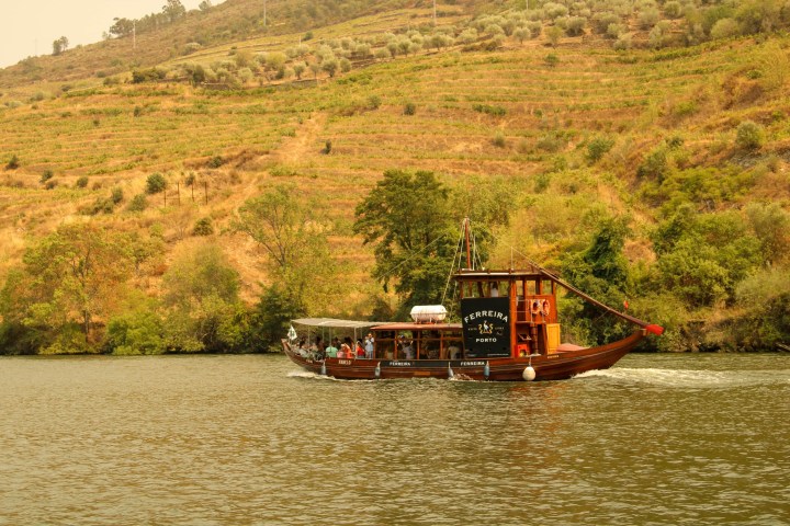 a boat traveling along a river next to a body of water