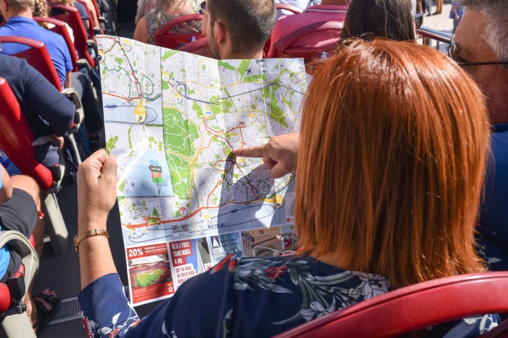 a group of people looking at a cell phone