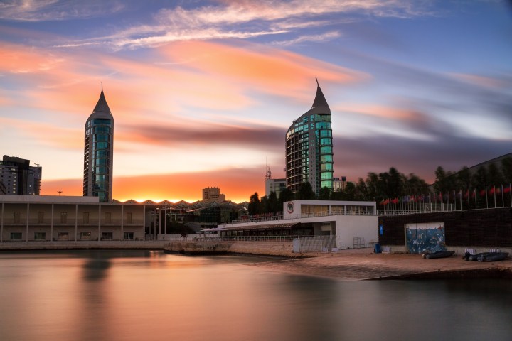 a large clock tower next to a body of water