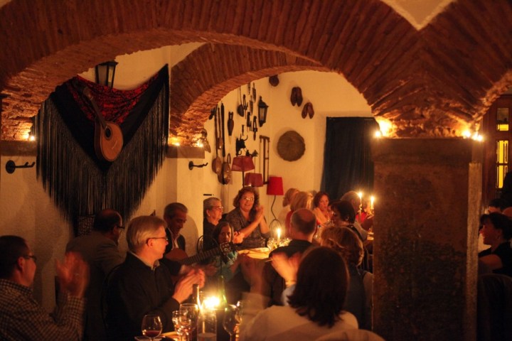 a group of people sitting at a table with wine glasses