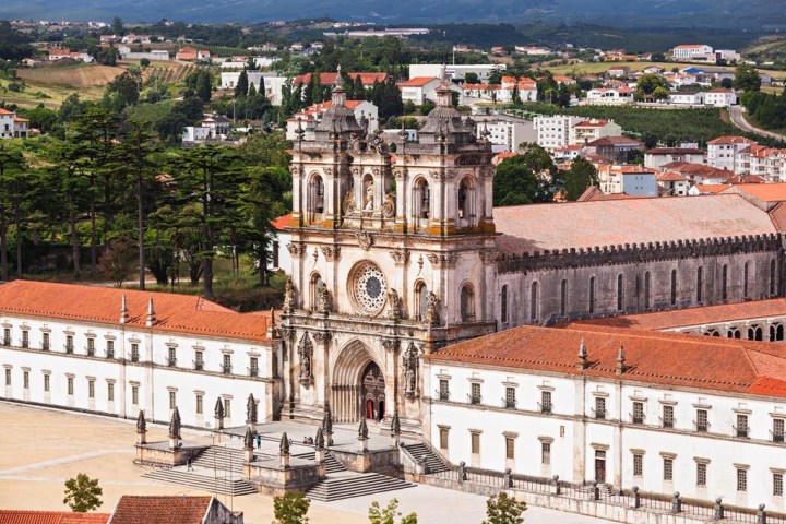 a large building with a mountain in the background