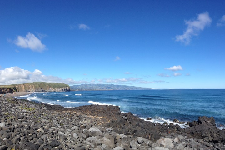 a rocky beach next to a body of water