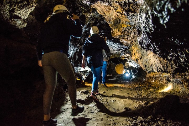 a couple of people that are standing in the dark