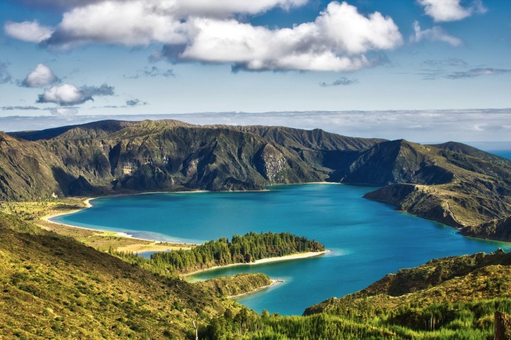 a body of water with a mountain in the background