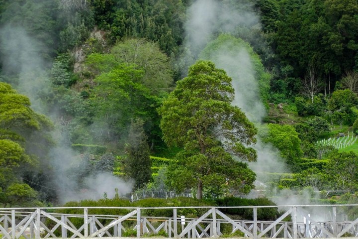 a steam train on a track with smoke coming out of it