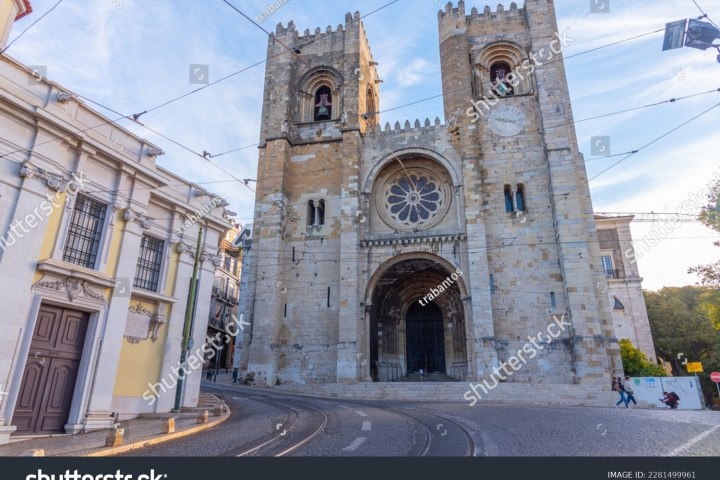 Front view of a historic cathedral with two towers on a sunny day.