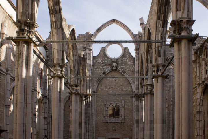 Ruins of a Gothic-style stone building with tall columns and arches.